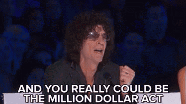 a man with curly hair is sitting in front of a microphone and says `` and you really could be the million dollar act ''