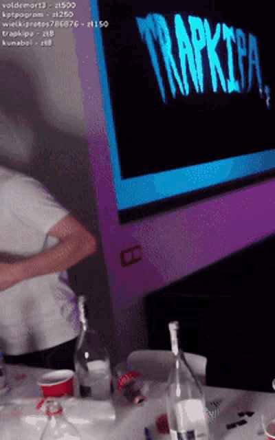 a man is standing in front of a screen that says trapkipa