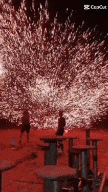 a man is standing in front of a fireworks display