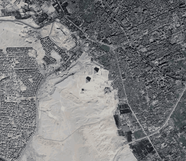 an aerial view of a city with pyramids in the middle