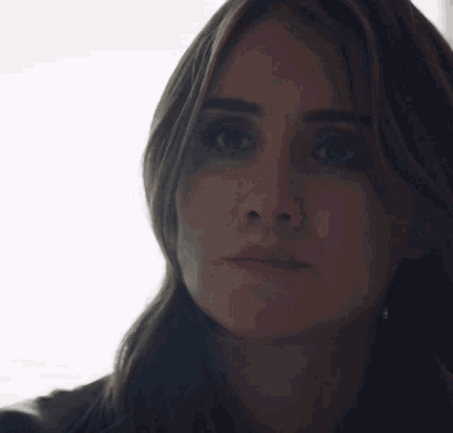 a close up of a woman 's face with her eyes closed