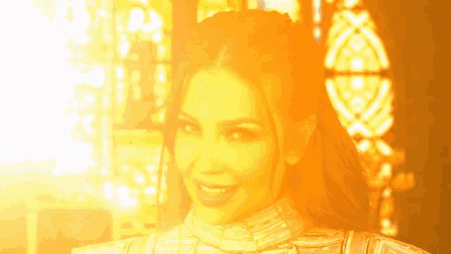 a woman with a yellow background is smiling