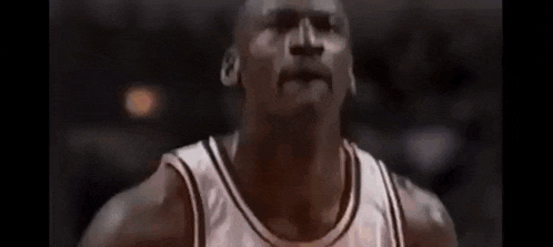 a basketball player is jumping in the air with his arms in the air during a game .