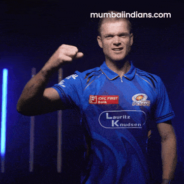 a man wearing a blue shirt that says mumbai indians