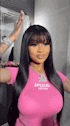a woman with long black hair is wearing a pink shirt and a pink necklace .