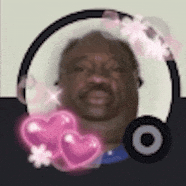 a man with a mustache is in a circle with pink hearts and flowers around him .