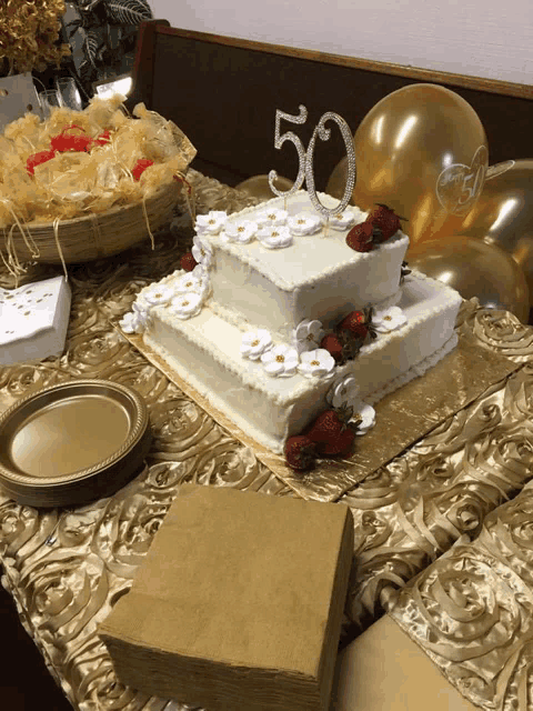 a 50th anniversary cake with strawberries and flowers