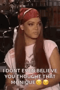 a woman with long red hair is wearing a bandana and a t-shirt .