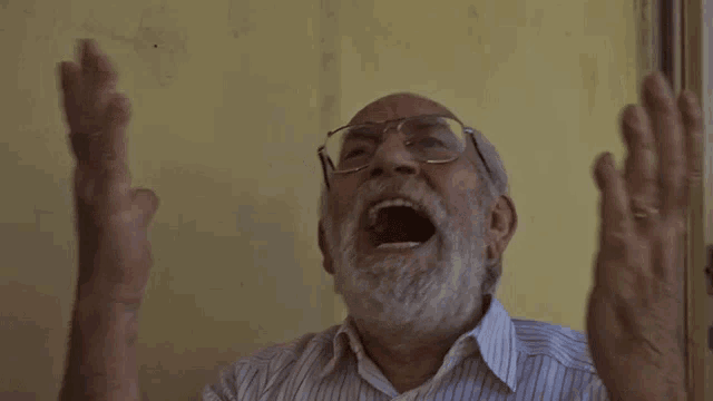 an older man with glasses and a beard is screaming with his mouth open
