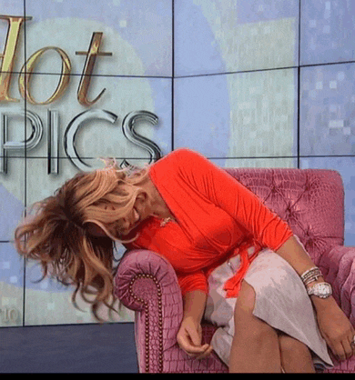 a woman sitting in a pink chair with the words hot pics behind her