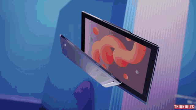a computer monitor is floating in the air with the words think jules written below it