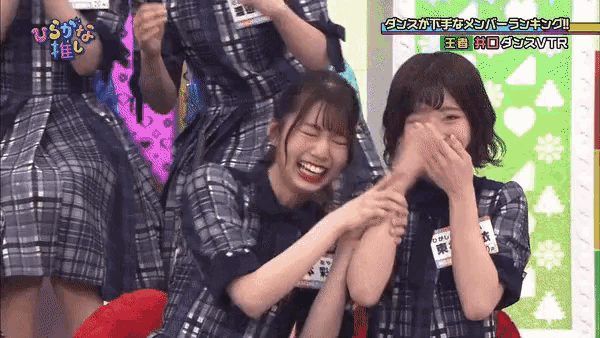 a group of girls are laughing and one of them has a name tag that says ' t.p. ' on it