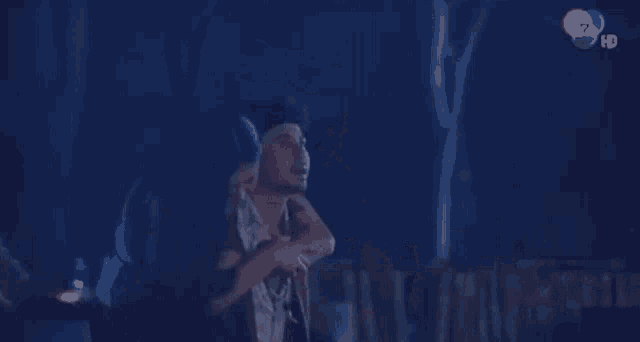 a man is carrying a woman in his arms in a dark room .