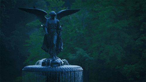 a fountain with a statue of an angel on top