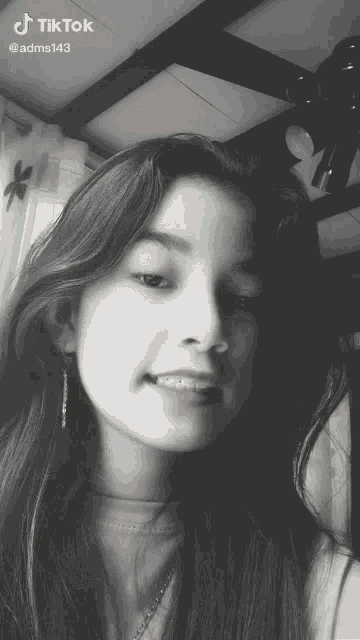 a girl 's face is shown in a black and white photo with a tiktok watermark