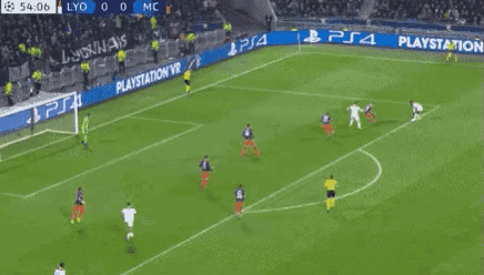 a soccer game is being played on a field with playstation ads on the sidelines