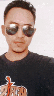 a man wearing sunglasses and a t-shirt that says jeep takes a selfie