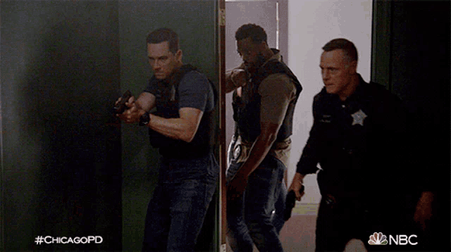a group of men are running through a hallway with the hashtag #chicagopd