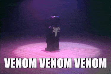 a lego venom figure is standing in front of a spotlight