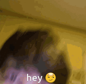 a yellow smiley face with the word hey written on it