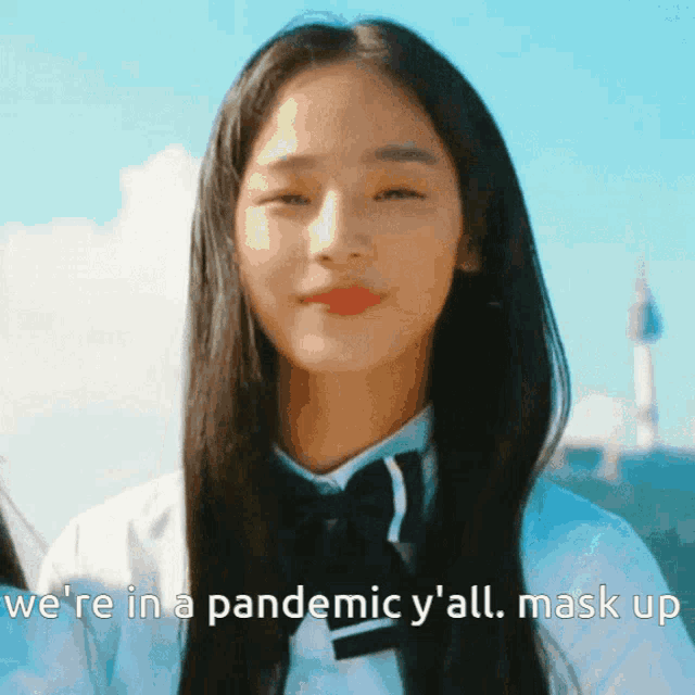 a woman wearing a white shirt and black bow tie says we 're in a pandemic y 'all