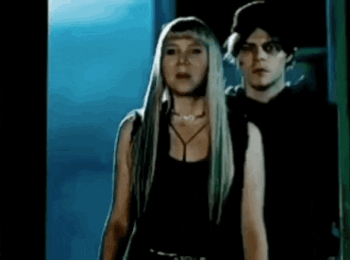 a man and a woman are standing next to each other .
