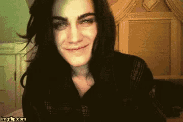 a woman with long black hair is smiling and looking at the camera while using imgflip.com