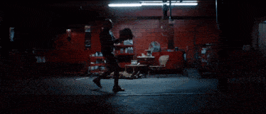 a man is laying on the floor in a dark room