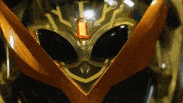 a close up of an alien 's face with a jewel in the center