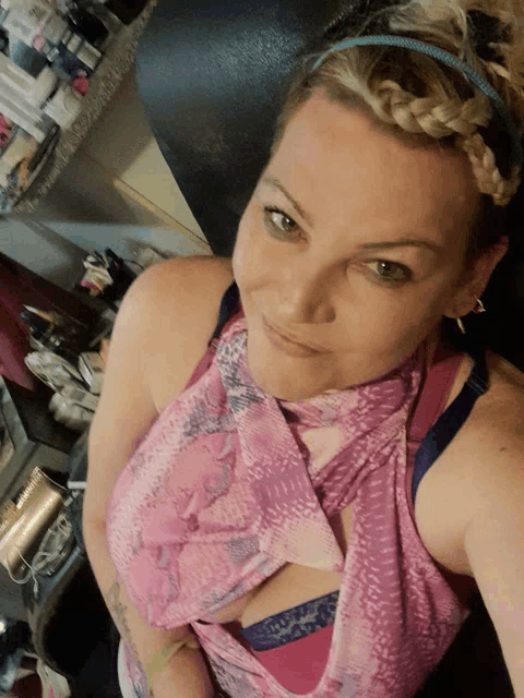 a woman wearing a pink tank top and a blue bra