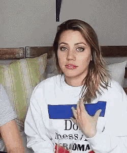 a woman wearing a sweatshirt that says do mess on it