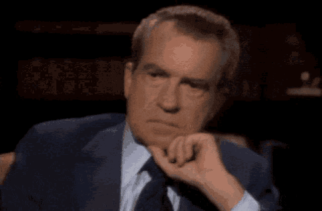 a man in a suit and tie says " well when the president does it "