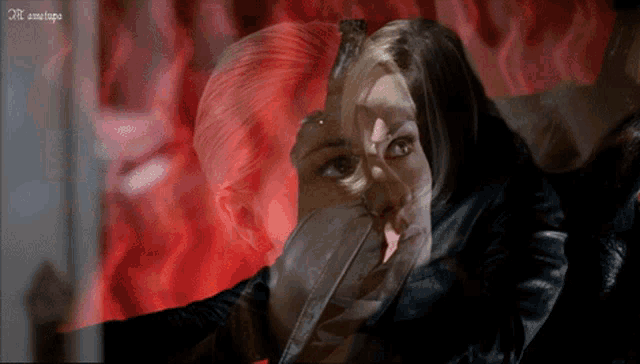 a blurry picture of a woman 's face with a red background and the letters nl on the bottom left corner