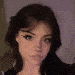 a close up of a woman 's face with a blurred background and a purple background .