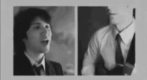 a man in a suit and tie is talking to another man