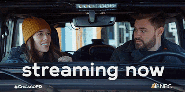 a man and a woman are sitting in a car with the words streaming now on the screen