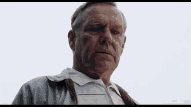 a close up of an older man 's face looking at the camera .