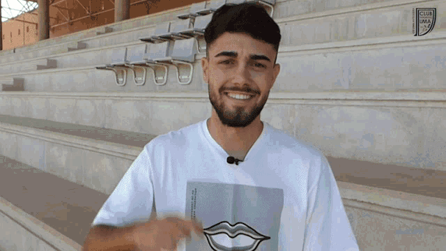 a man wearing a white shirt with a picture of a mouth on it