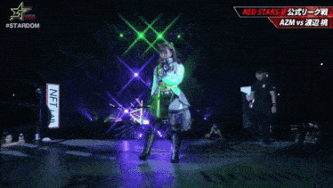 a female wrestler named azm is standing on stage