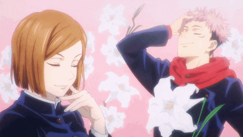 a boy and a girl are standing next to each other with flowers in the background