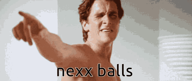 a shirtless man is pointing with the word nexx balls below him