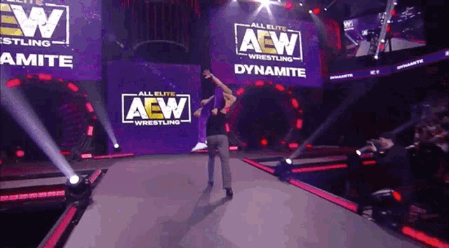 a wrestler is walking down the aisle of a aew wrestling event