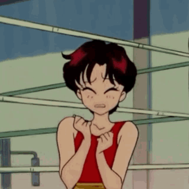a girl is standing in a boxing ring with her hands on her chest .