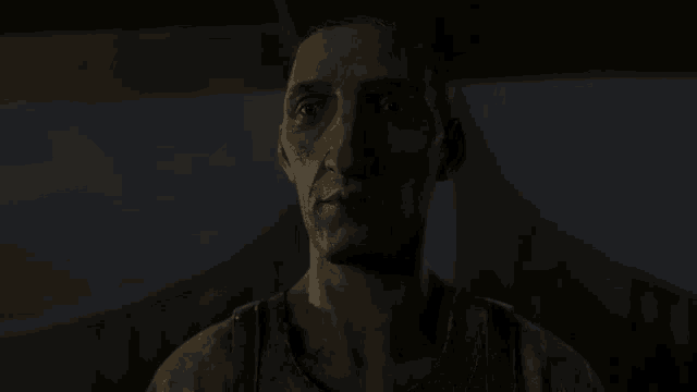 a close up of a man 's face in the dark
