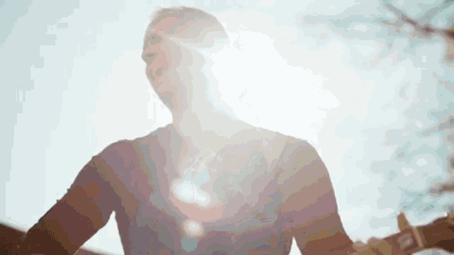 a man in a black shirt is singing into the sun