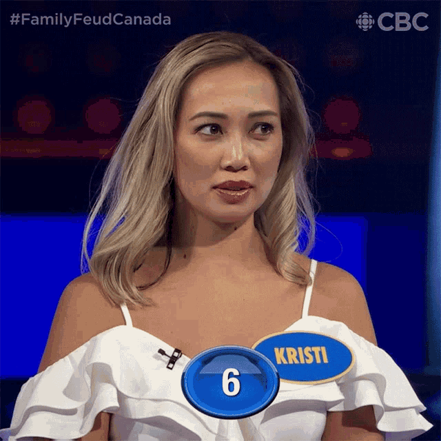a woman in a white dress with a name tag that says kristi