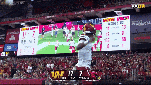 a football game is being played between the cardinals and the washington redskins