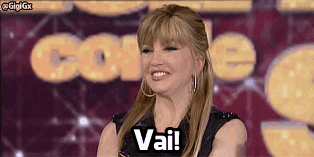 a woman says vai in front of a sign that says come on it