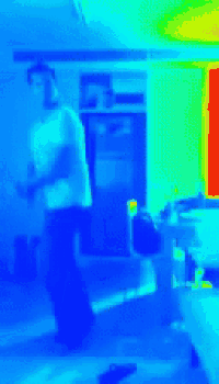 a blurry picture of a person standing in a room with a blue background