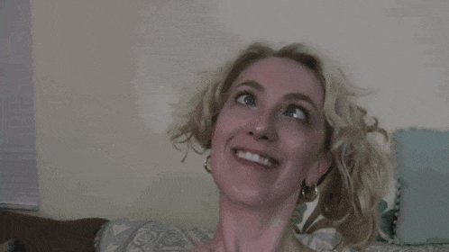 a close up of a woman 's face with a smile on her face